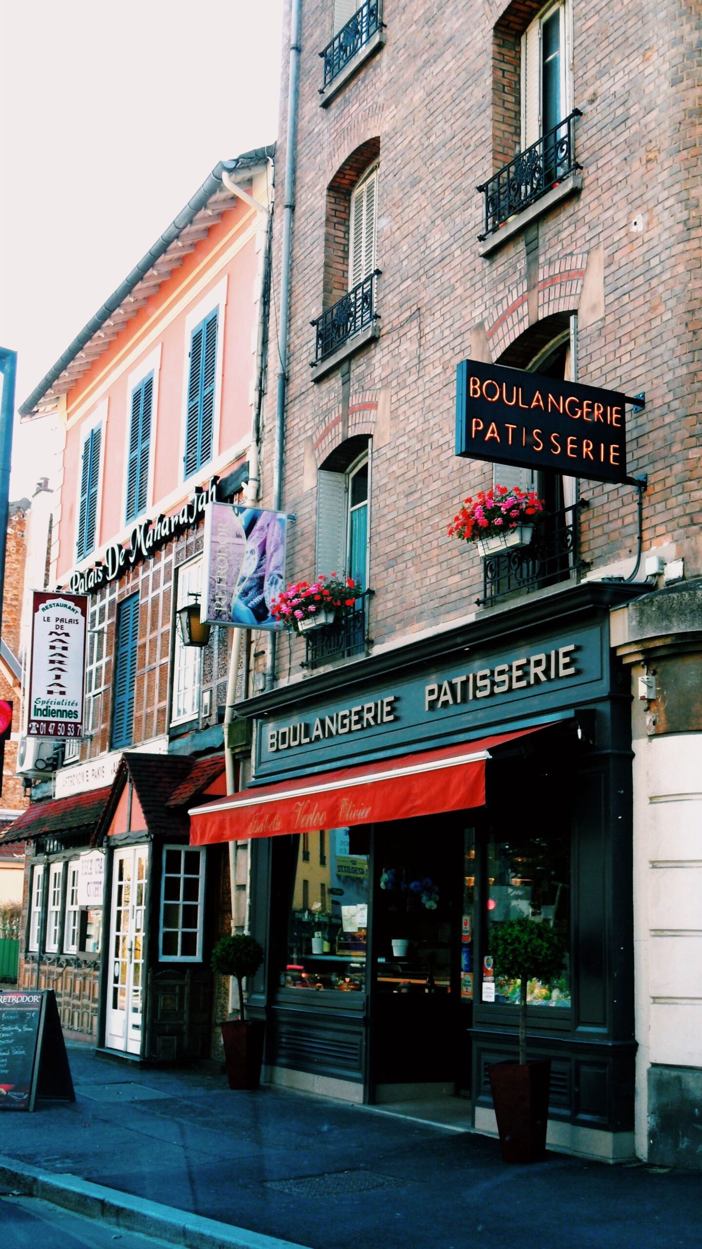 Traditional French boulangerie and patisserie storefront on a quiet street